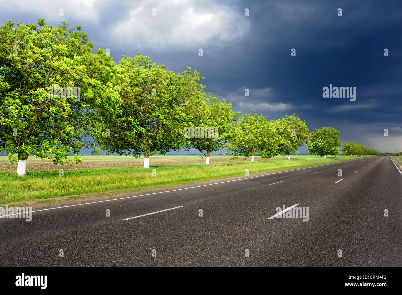landscape with road and dark sky Stock Photo - Alamy
