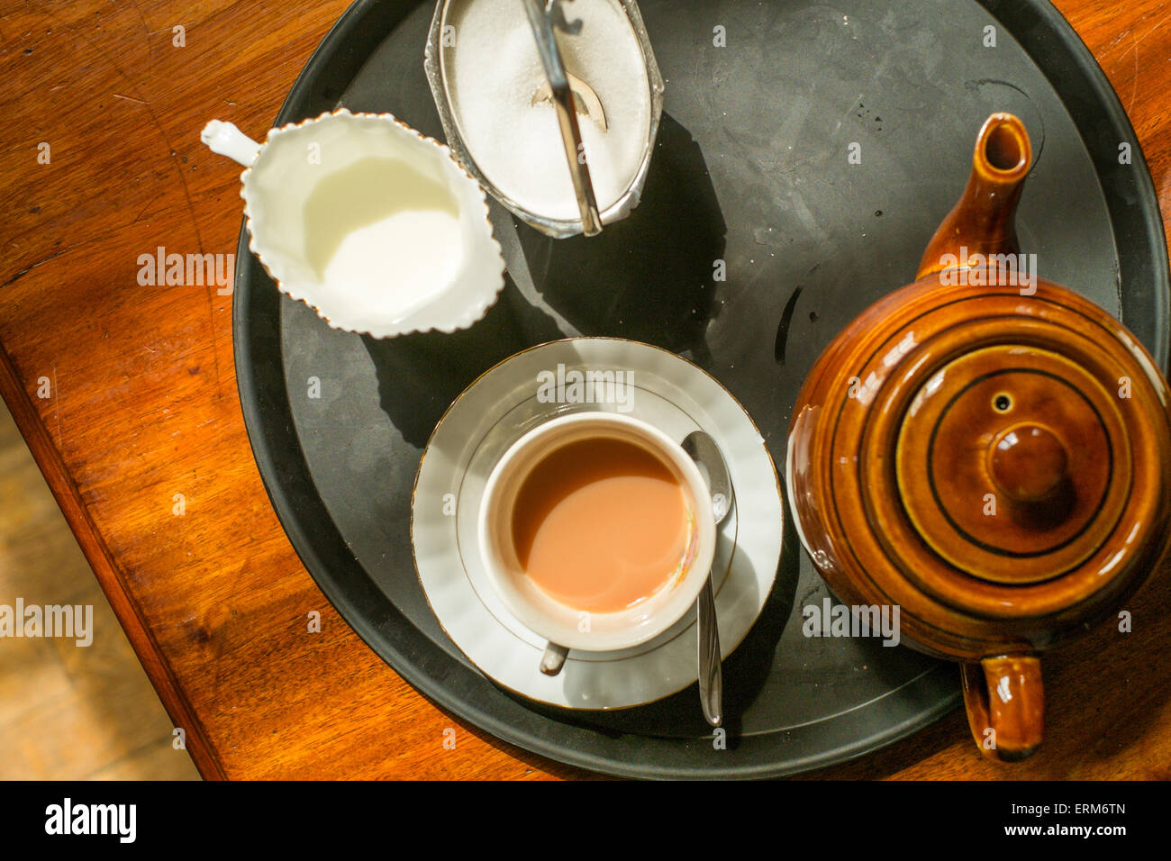 Tea for one. Ceramic teapot, cup, saucer, sugar bowl and jug of milk on