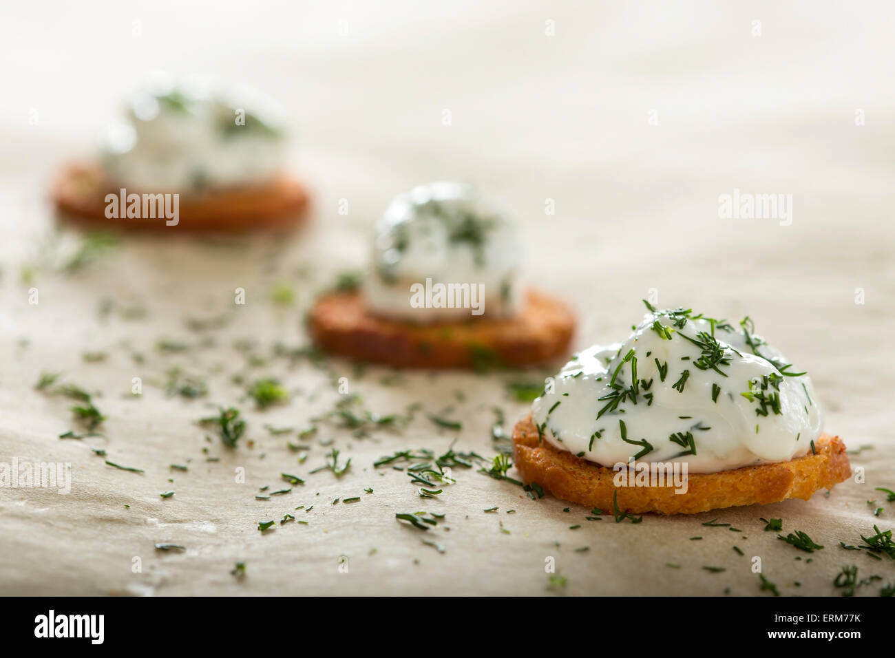 Fresh cream cheese spread with dill on bake rolls Stock Photo