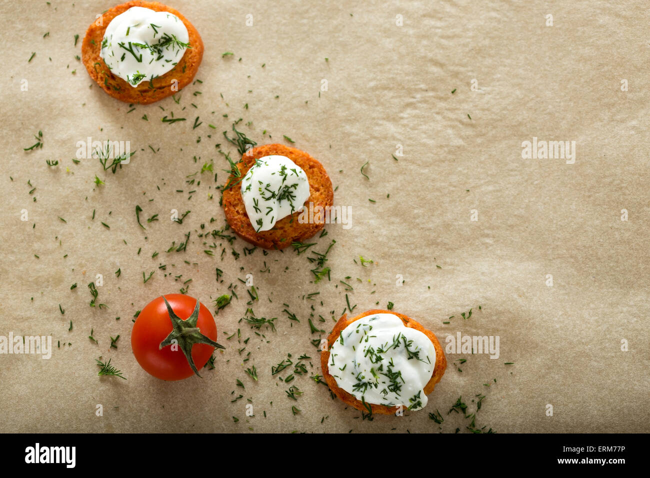 Fresh cream cheese spread with dill on bake rolls and cherry tomato
