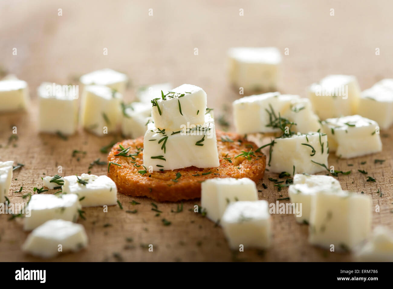 Close up of one antipasto with cheese and dill over wood background Stock Photo