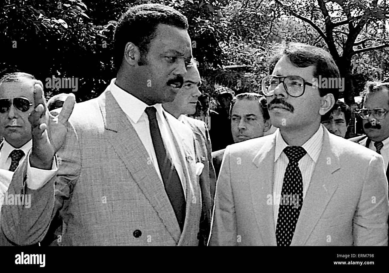 Chicago, Illinois, USA 2nd August 1986 Nicaraguan President Daniel Ortega with the Rev. Jesse Jackson outside Operation Push headquarters. The Nicaraguan FIrst Lady  Rosario Murillo who is a polyglot translates for him. ``Nicaragua is willing to negotiate with the United States toward a treaty of peace and friendship. We are willing to sign a treaty of peace and friendship with the United States immediately.`` Ortega also invited Reagan to visit Nicaragua and meet with top officials as well as the Nicaraguan people.  Credit: Mark Reinstein Stock Photo