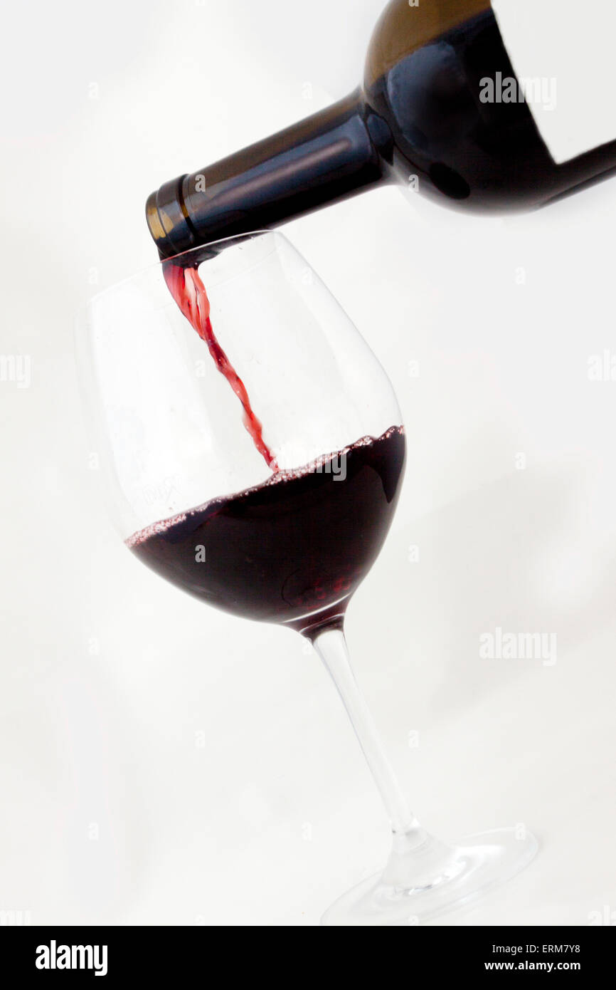 Blank Red Wine Bottle pouring into glass Stock Photo Alamy