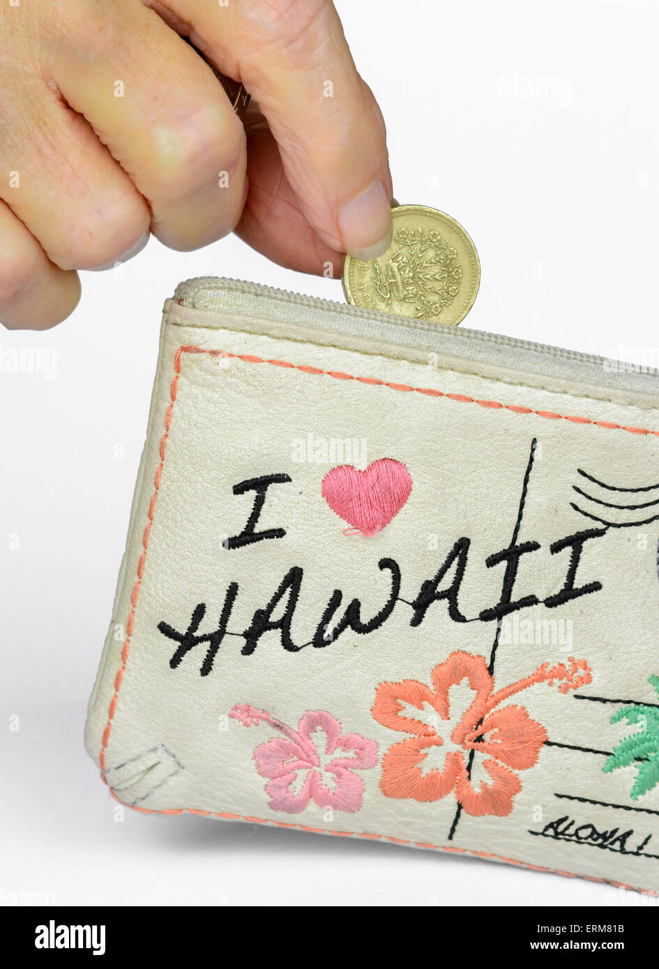 Dropping a coin into a purse. Savings concept. Saving money. Stock Photo