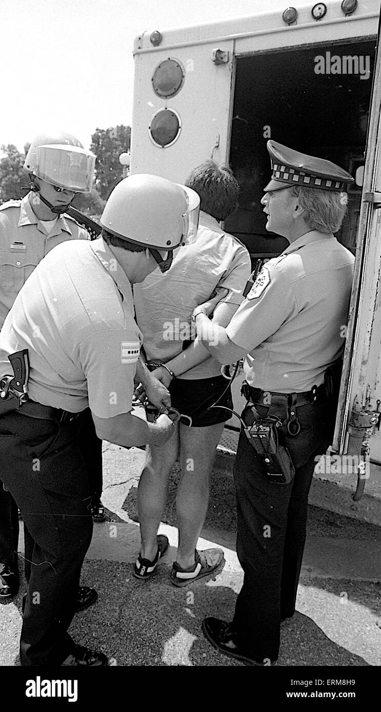Chicago, Illinois, USA 28th June 1986  Chicago police show the pistol man was carrying after they arrested him and took him to paddy wagon during KKK rally in the Marquette Park area. Credit: Mark Reinstein Stock Photo