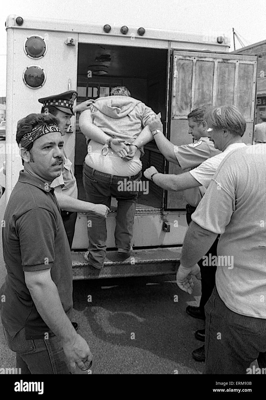 Chicago, Illinois, USA 28th June 1986 Members of the Chicago police tactical squad arrest man in bar and then take him to paddy wagon during KKK rally in the Marquette Park area. Credit: Mark Reinstein Stock Photo