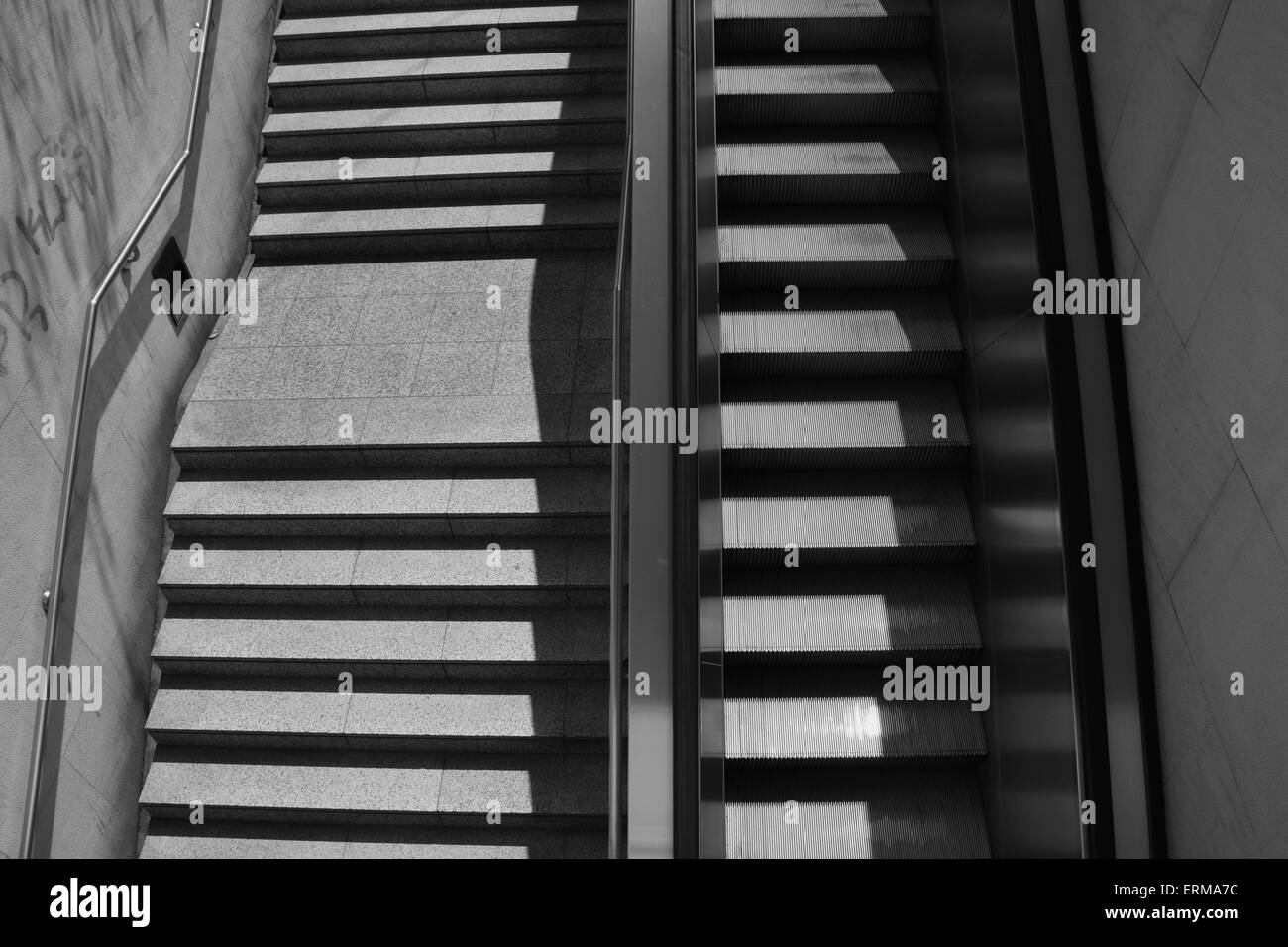 Staircase steps with handrail and escalator. Black and white. Stock Photo
