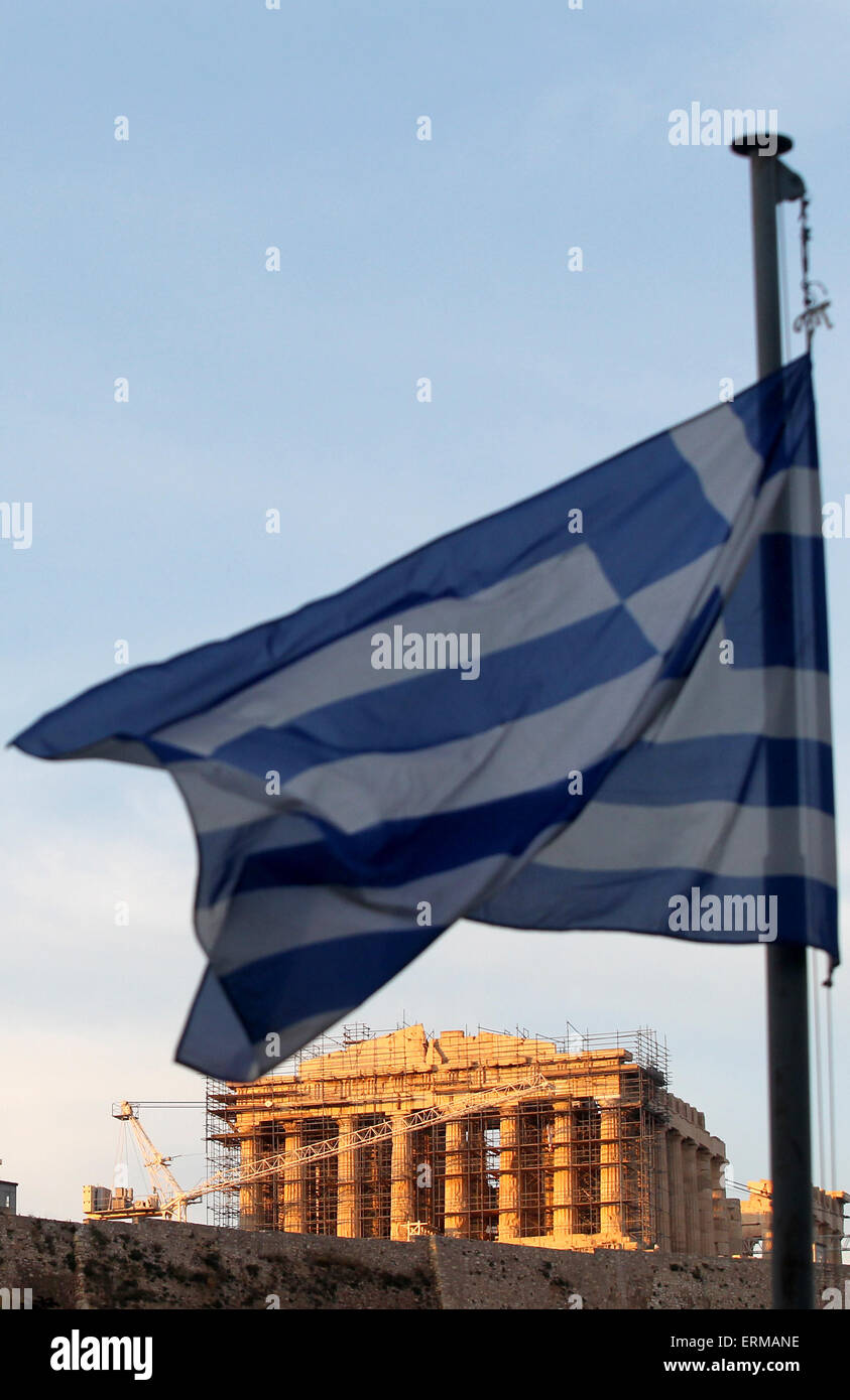 Athens, Greece. 4th June, 2015. The Greek flag flies while the sun sets over the Acropolis, in Athens, Greece, on June 4, 2015. Ongoing negotiations to keep Greece from bankruptcy reached a critical point. The Greek government on Thursday expressed optimism over a 'mutually acceptable' deal with international creditors on the country's debt repayment arrangements following the latest inconclusive talks in Brussels. © Marios Lolos/Xinhua/Alamy Live News Stock Photo