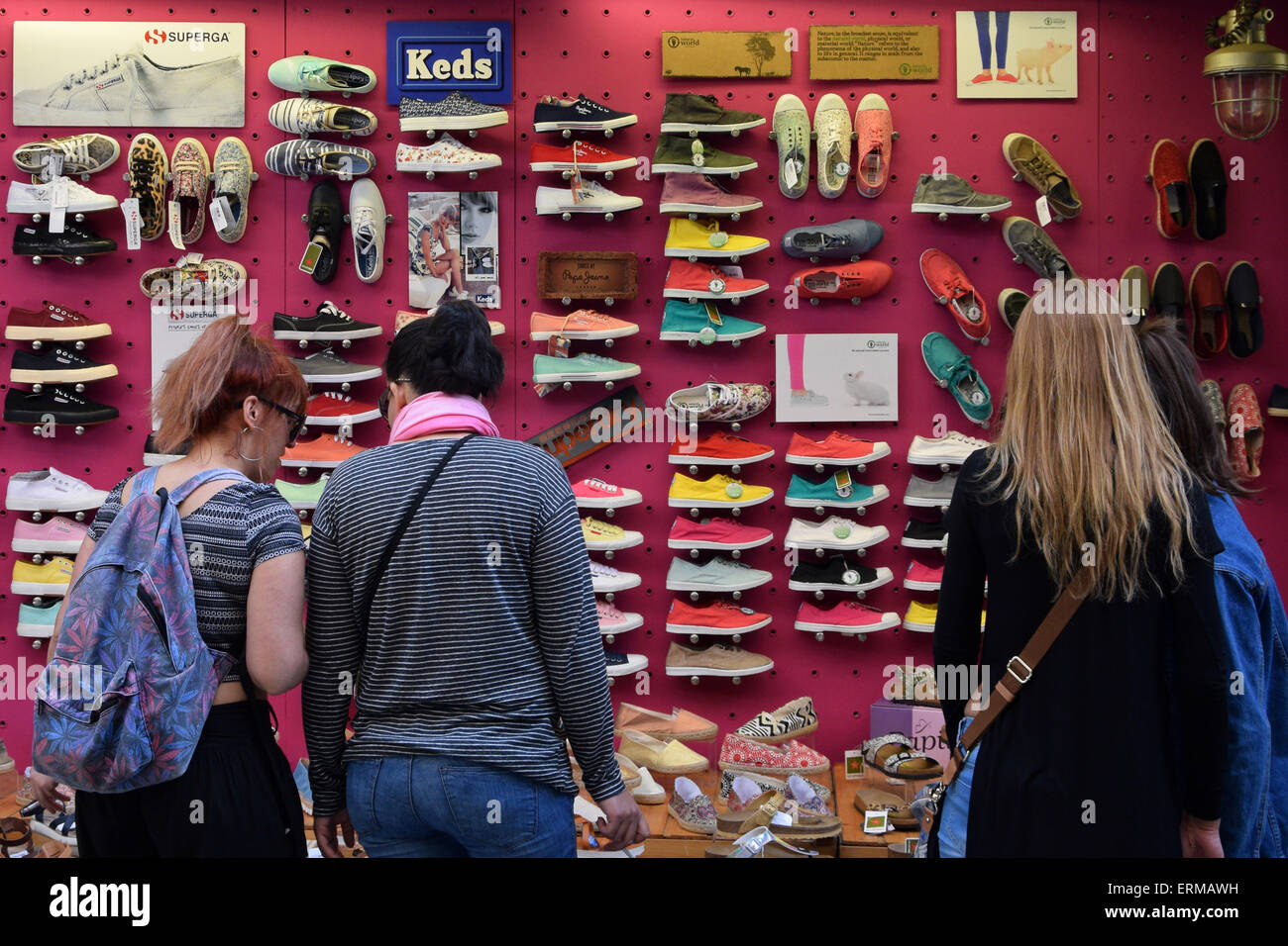 Women looking at storefront with casual shoes and footwear. Stock Photo