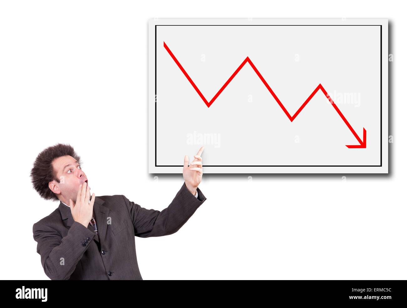 Shocked man in a suit shows a hand on the board with a declining arrow Stock Photo