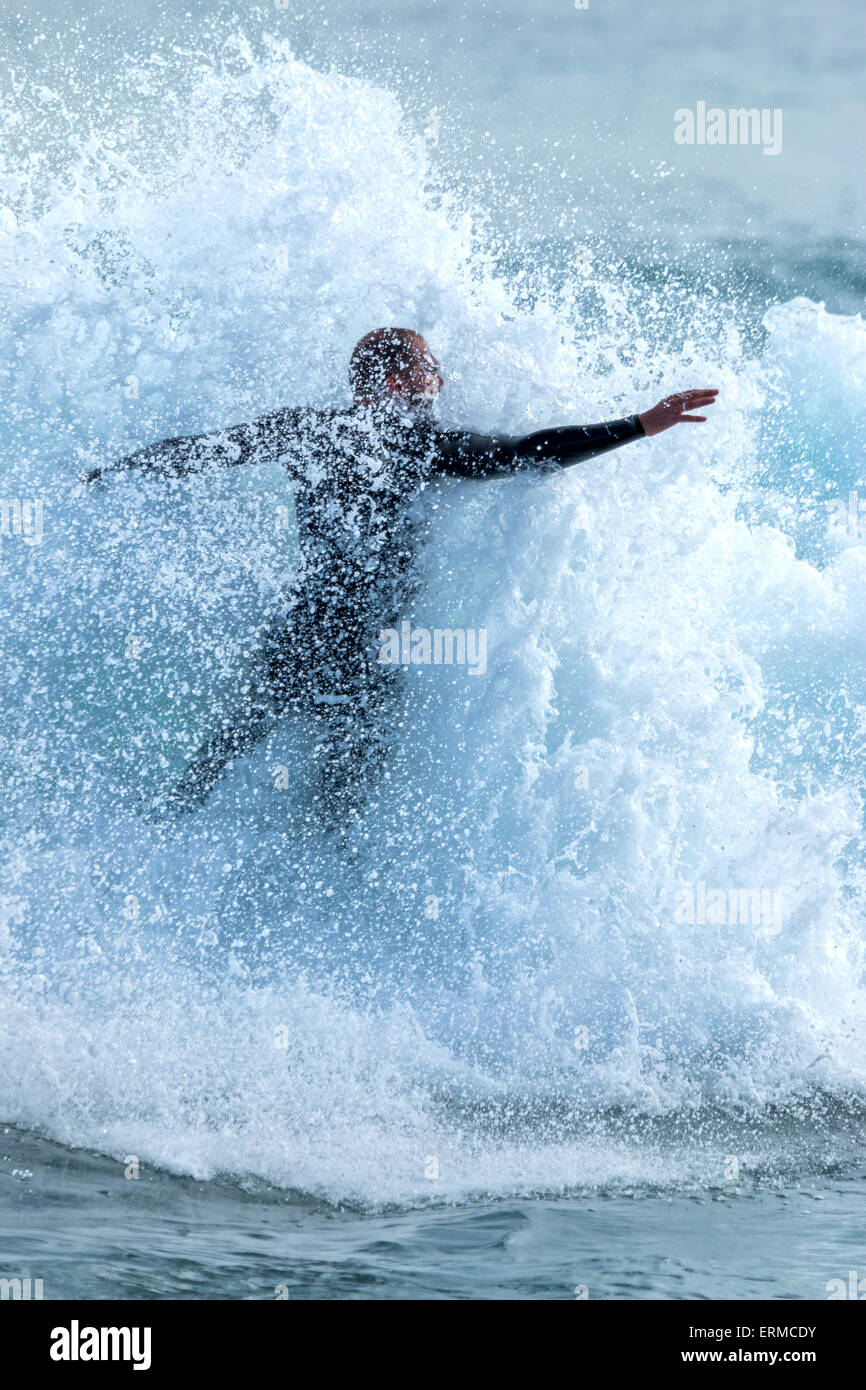 Surfer on Blue Ocean Wave with many drops Stock Photo