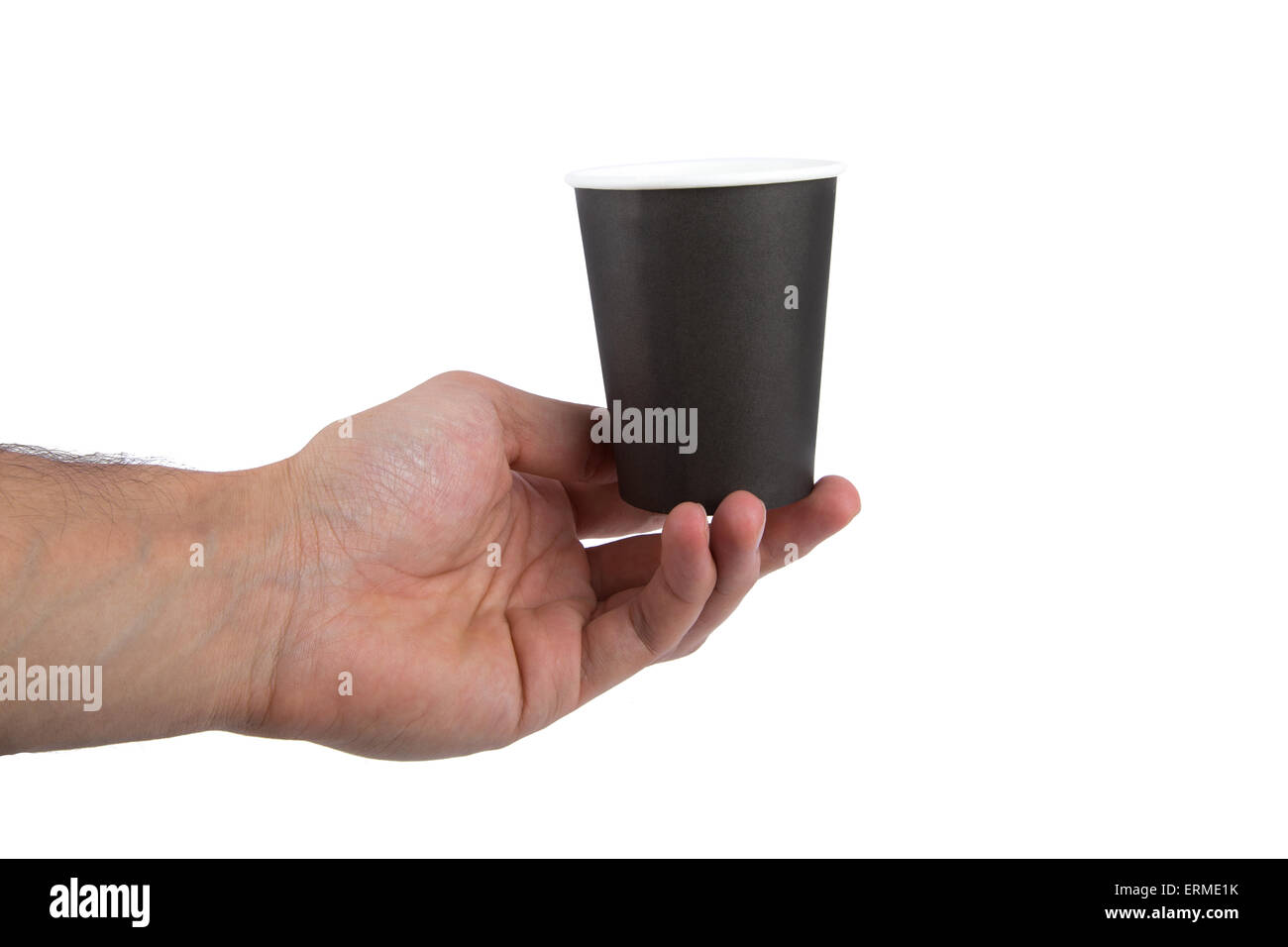 Close up front view of recycled black paper glass holding on hand, isolated on white background. Stock Photo