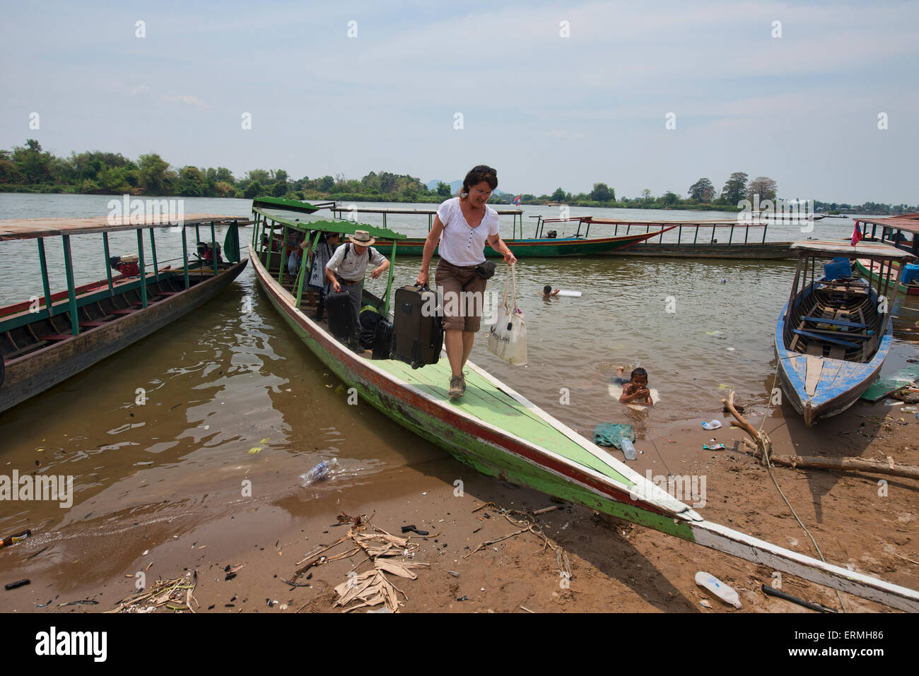 Tourists getting off a longtail boat, Don Khon Island, Laos Stock Photo