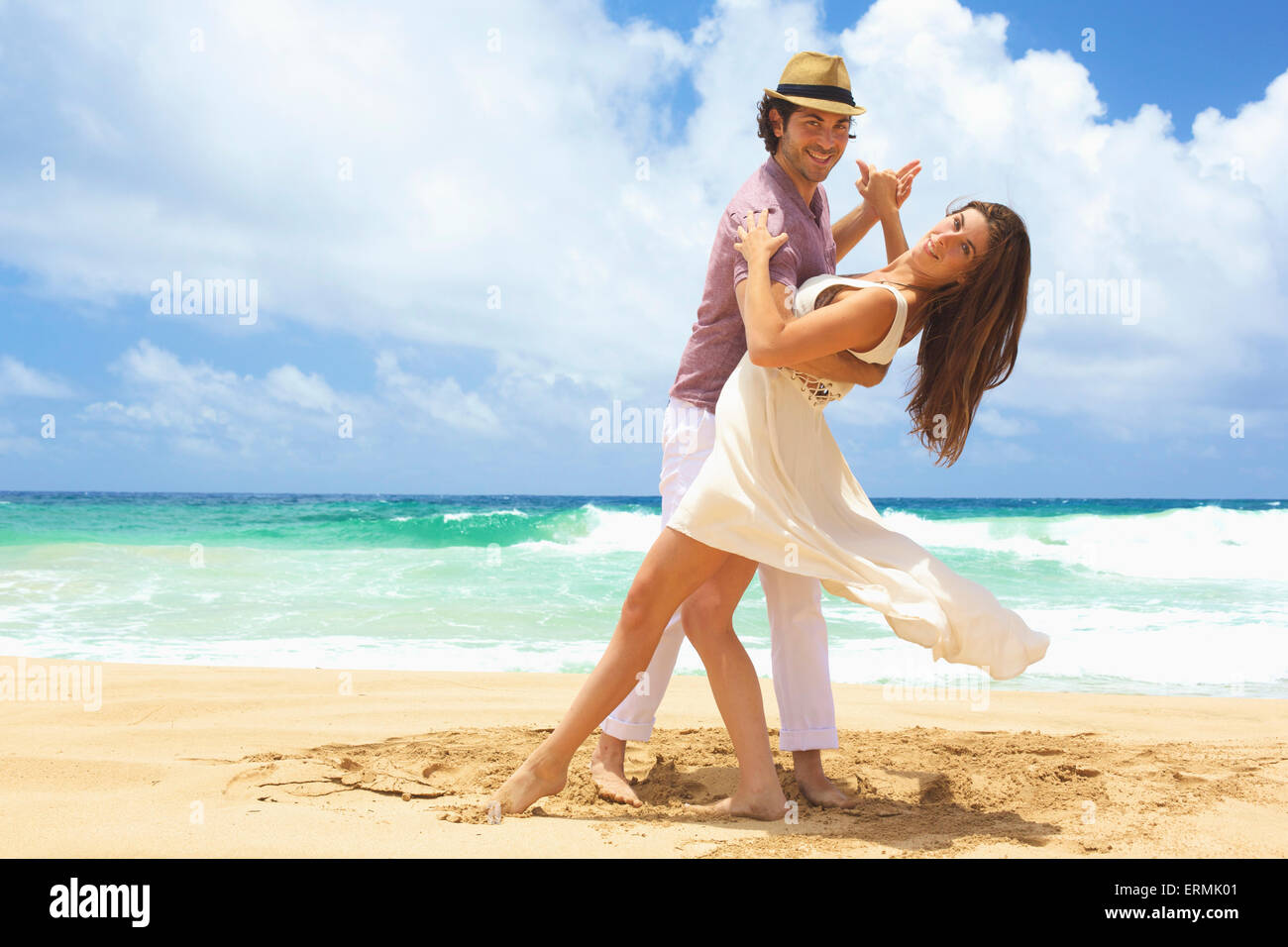 Portrait of couple dancing on the beach; Kealia, Kauai, Hawaii, United States of America Stock Photo