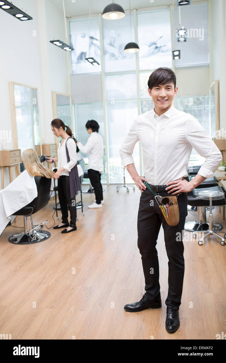 Barbers working in barber shop Stock Photo Alamy