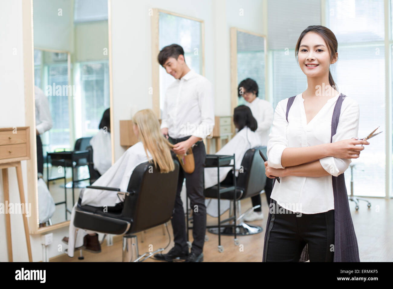 Barbers working in barber shop Stock Photo Alamy