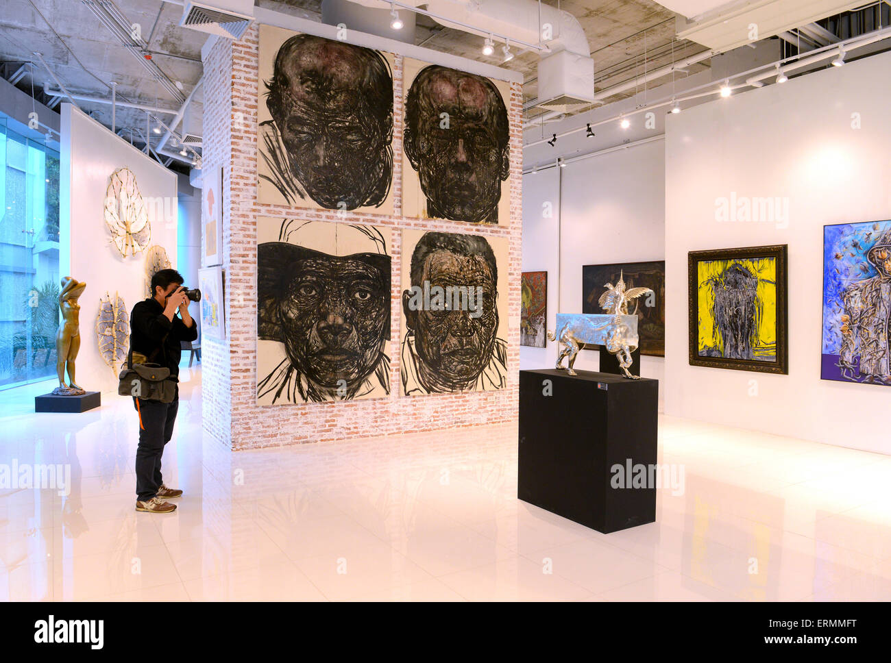 BANGKOK - NOVEMBER 28: Visitors are shooting the arts in Thai Contemporary Art Exhibition on November 28, 2014 at Hof Art Galler Stock Photo