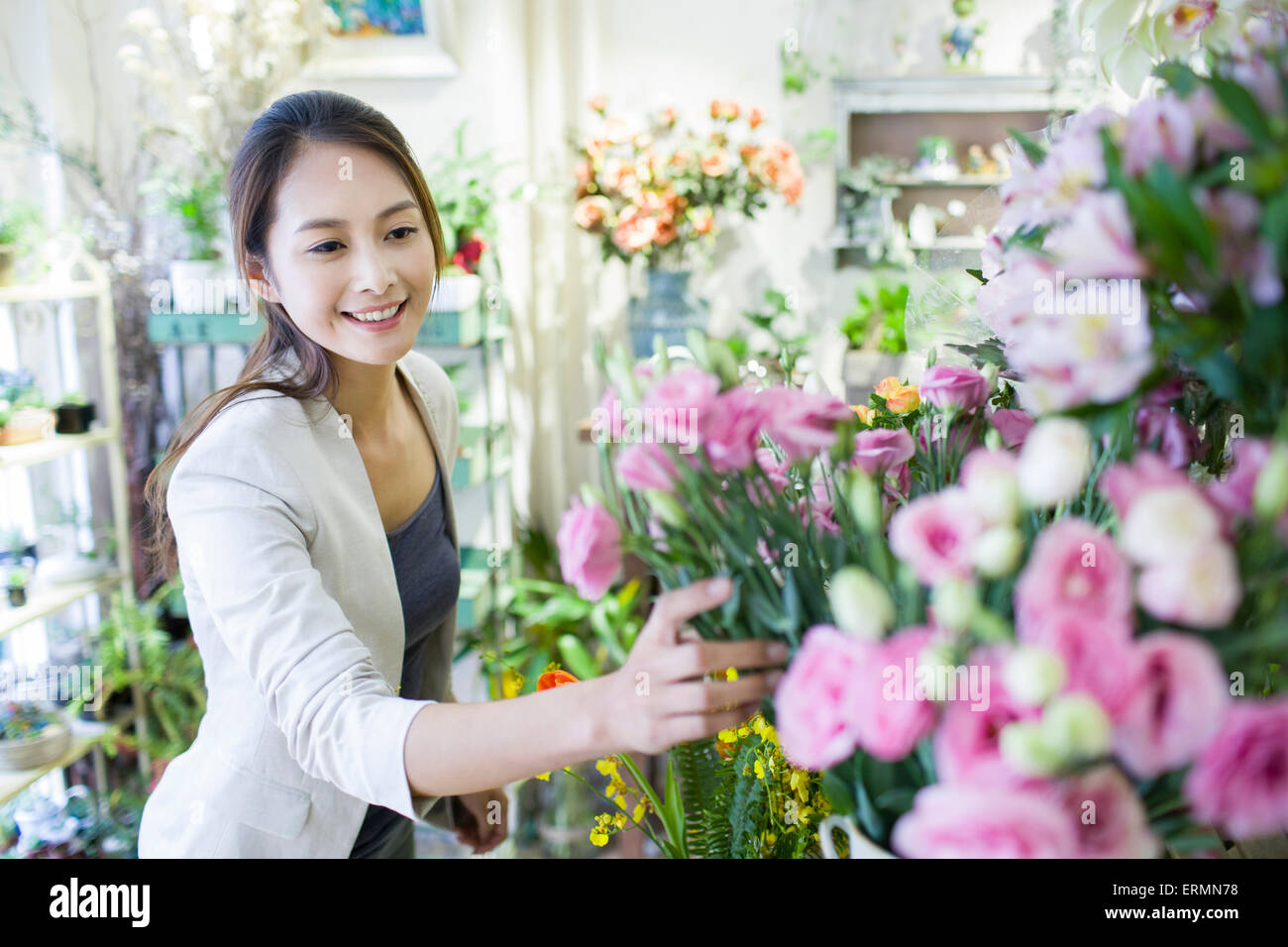 Young woman buying flowers Stock Photo Alamy