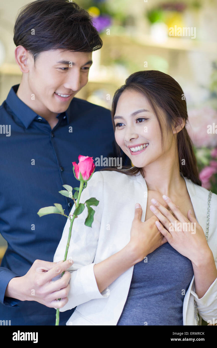 Young man giving flower to girlfriend Stock Photo Alamy