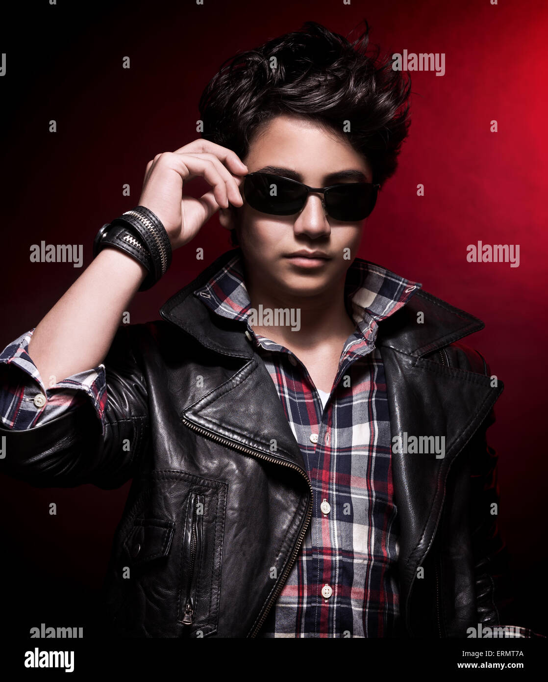 Portrait of handsome teen boy wearing stylish sunglasses and