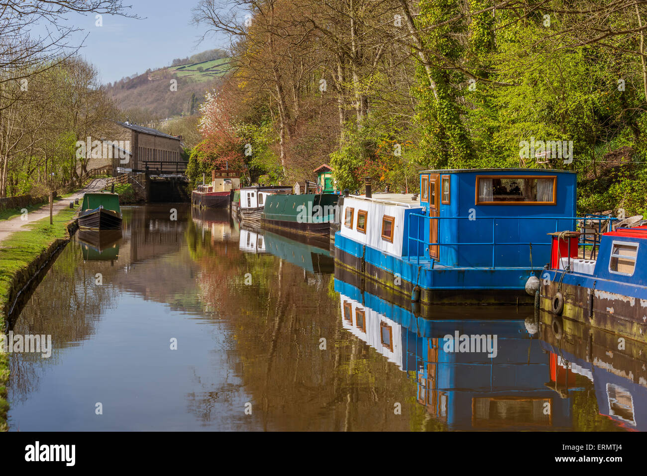 Canal narrowboats at the moorings close to the west Yorkshire town of Hebden Bridge, Calderdale. Stock Photo