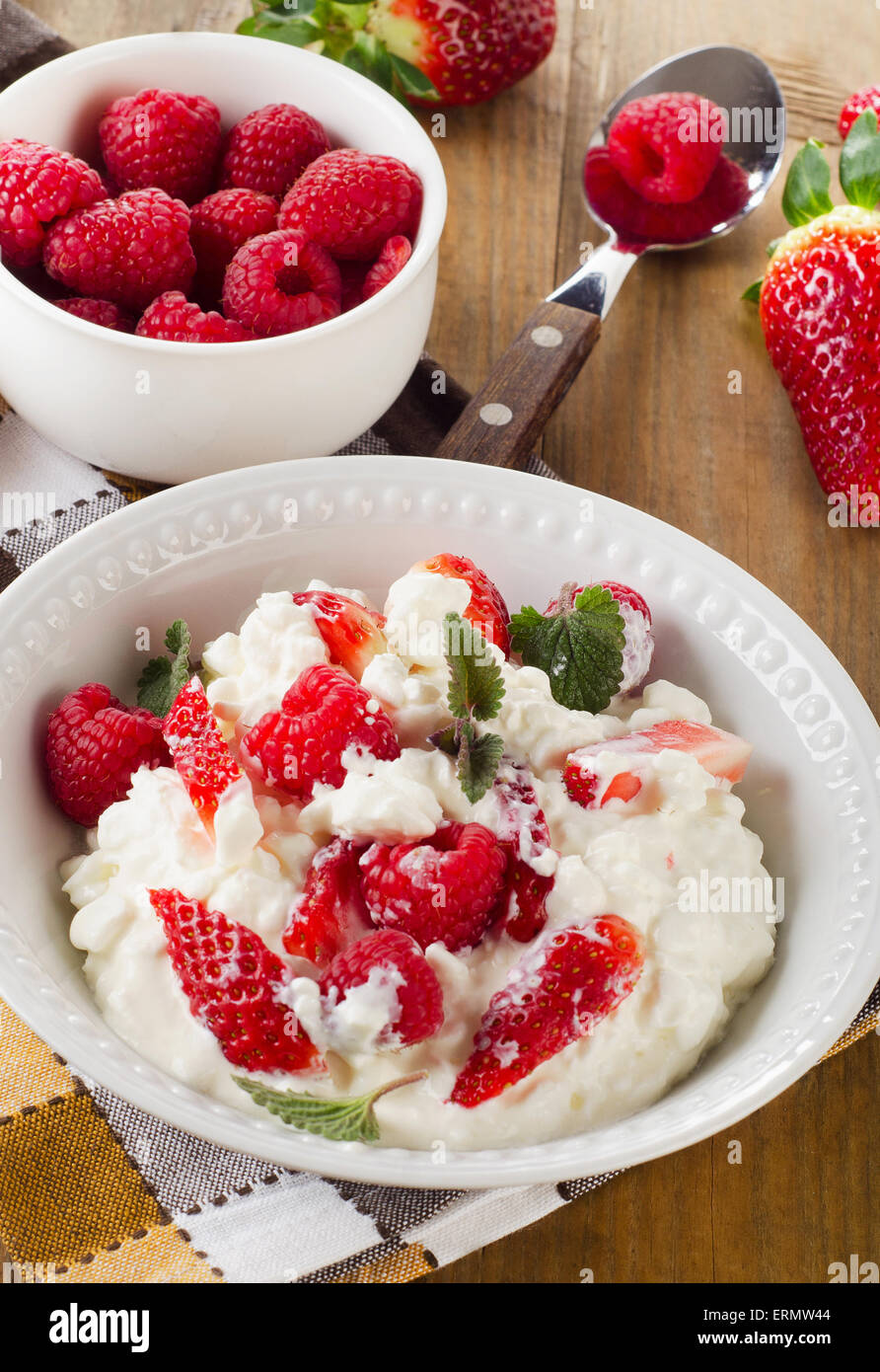 Fresh Cottage cheese with berries on  a wooden table. Top view. Stock Photo