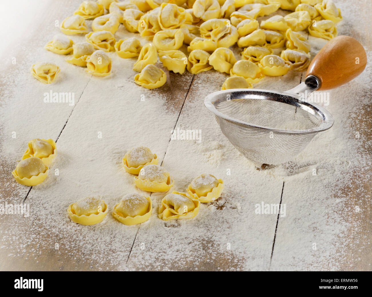 Freshly Made Ravioli pasta on  wooden table. Stock Photo