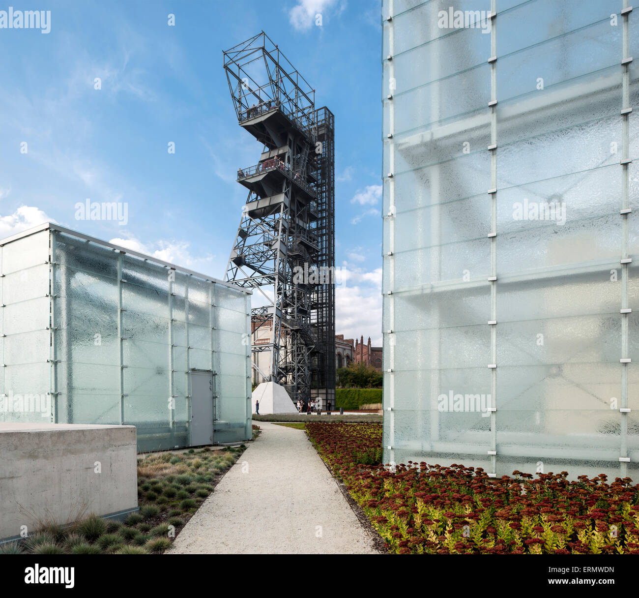Juxtaposition of glass cube and mining tower. Silesian Museum, Katowice, Poland. Architect: Riegler Riewe Architekten , 2014. Stock Photo