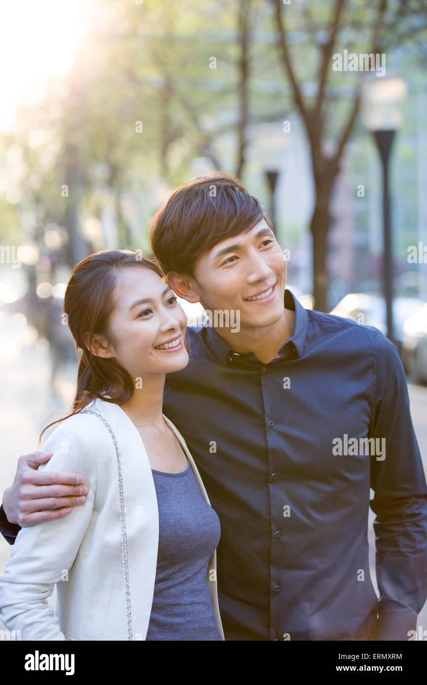 Two happy young women walking hand hand city hi-res stock photography ...