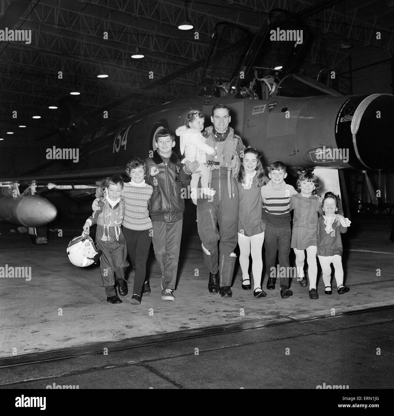 The First Royal Phantom Training Unit will be commissioned at the Royal Training Air Station in Yeovilton, Somerset. Lieutenant Commander Peter Marshall has been chosen to lead the training of the pilots and observers who will fly the fighter version of the aircraft. Here he is pictured with his eight children  at the Air Station. 13th January 1969. Stock Photo