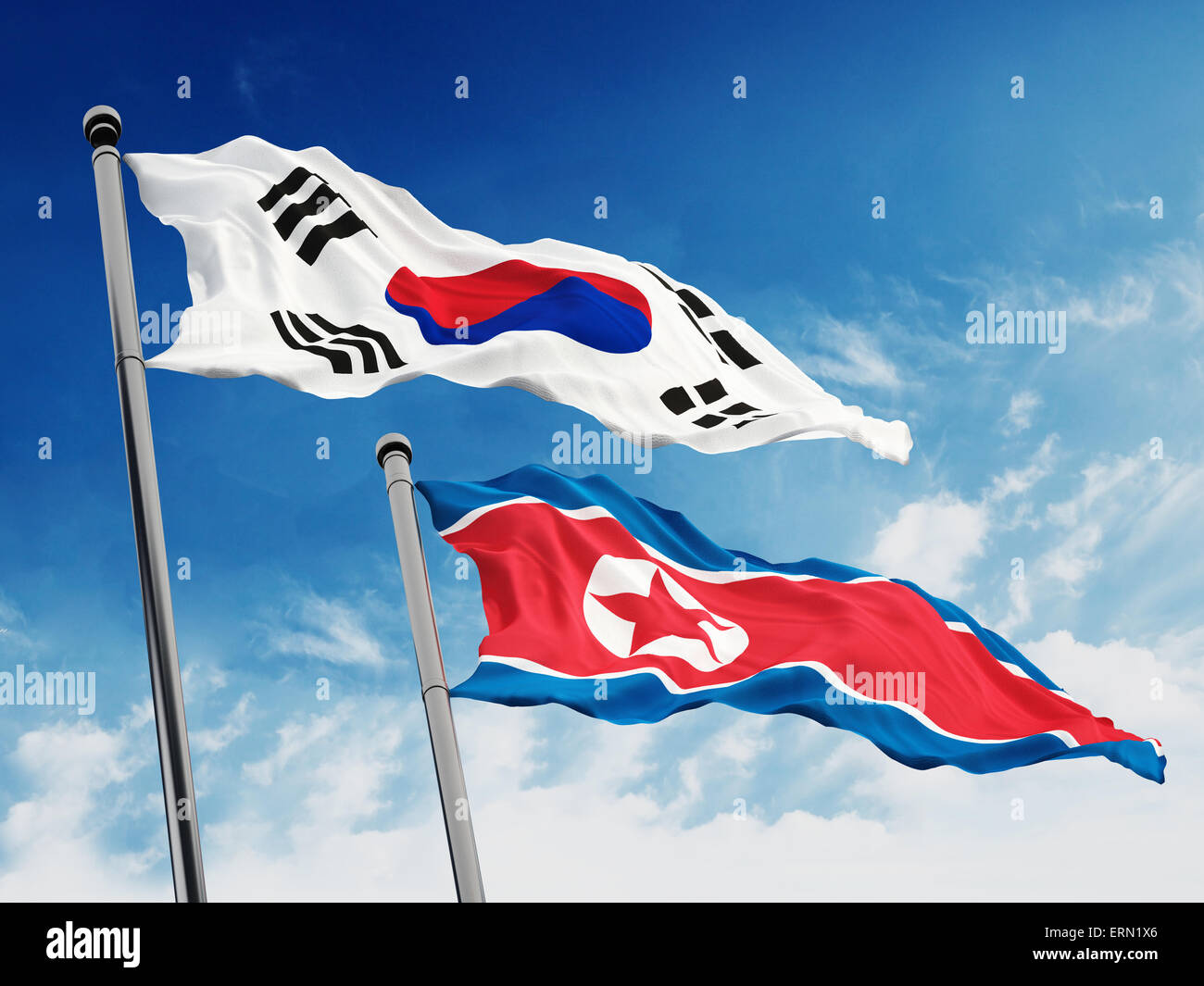South and North Korea flags against blue sky background. Stock Photo
