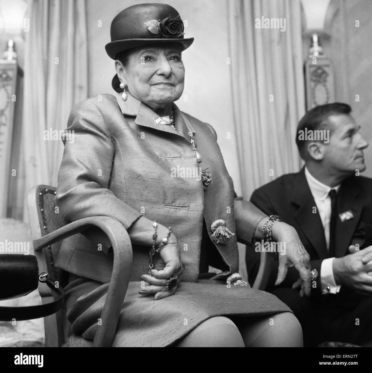 Business woman Helena Rubinstein seen here at the Dorchester Hotel, London, with couturier and dressmaker to the Queen, Hardy Amies. Rubinstein was at a lunch given by her niece Maxla in her honour.  14th May 1963 Stock Photo