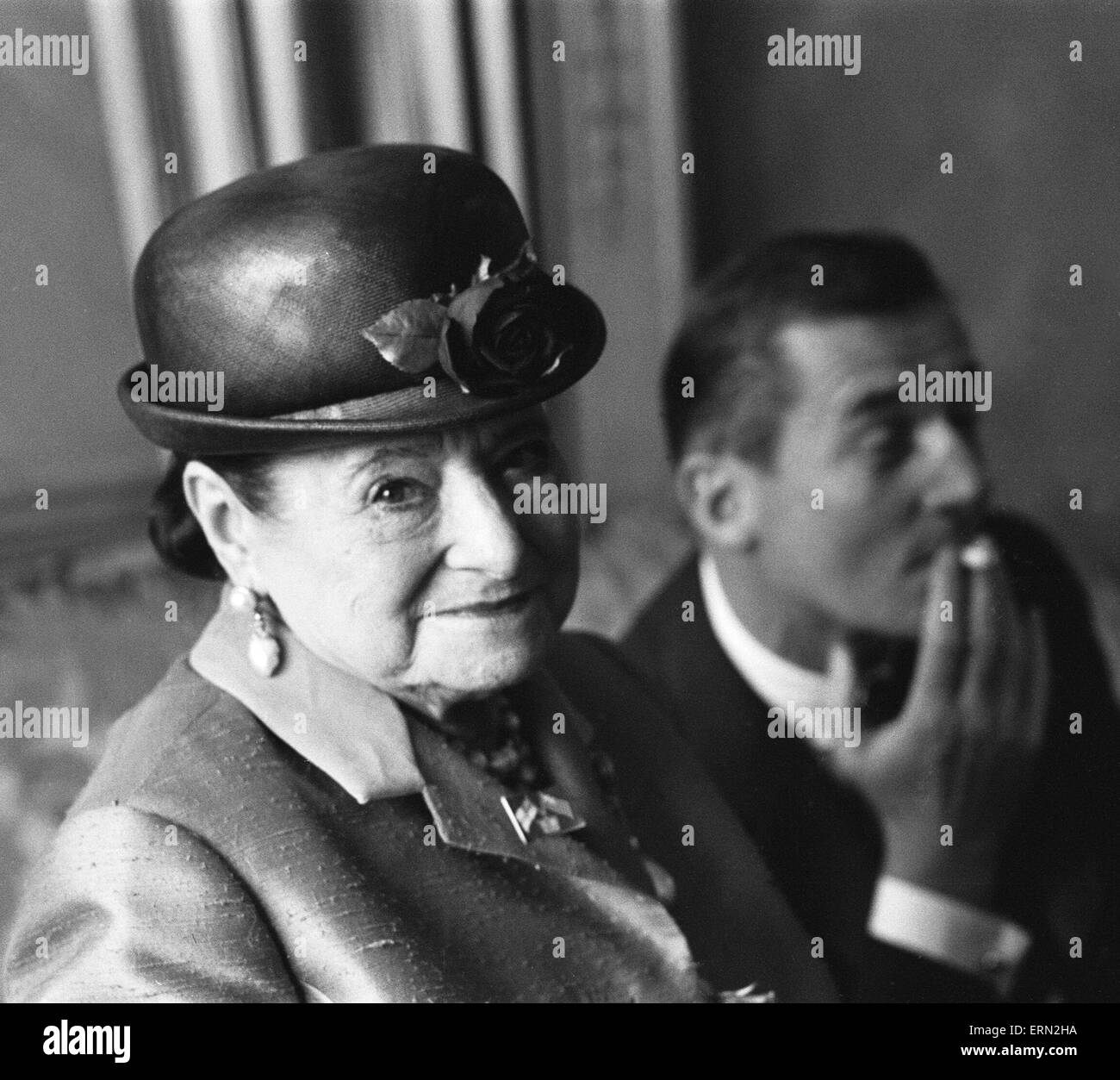 Business woman Helena Rubinstein seen here at the Dorchester Hotel, London, with couturier and dressmaker to the Queen, Hardy Amies. Rubinstein was at a lunch given by her niece Maxla in her honour.  14th May 1963 Stock Photo