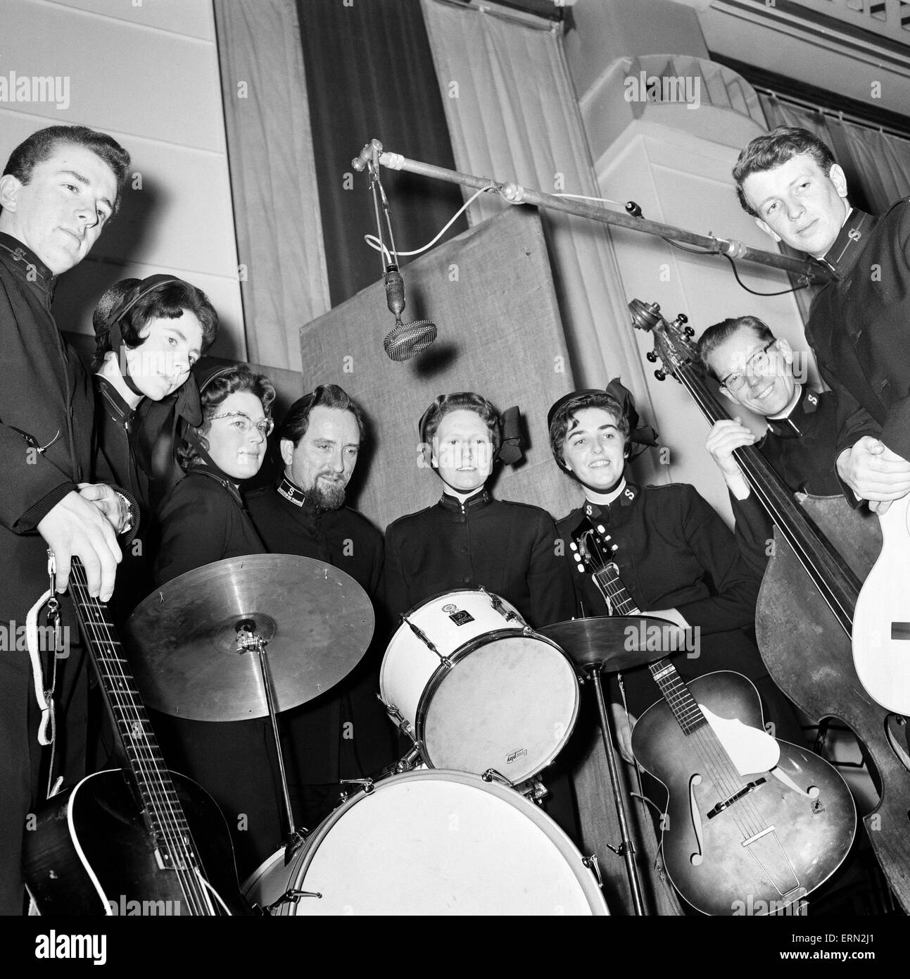 The Joystrings, Salvation Army pop group recording at the EMI recording studio in St John's Wood. L-R Bill Davidson (19); Brenda Alexander (20); Lillian Boot (24); Wycliffe Noble (37 drummer); Thelma Adams (21); Capt. Joy Webb (31, the leader) Capt. Handle Everett (40); Peter Dalziel (21), London, 19th December 1963 Stock Photo