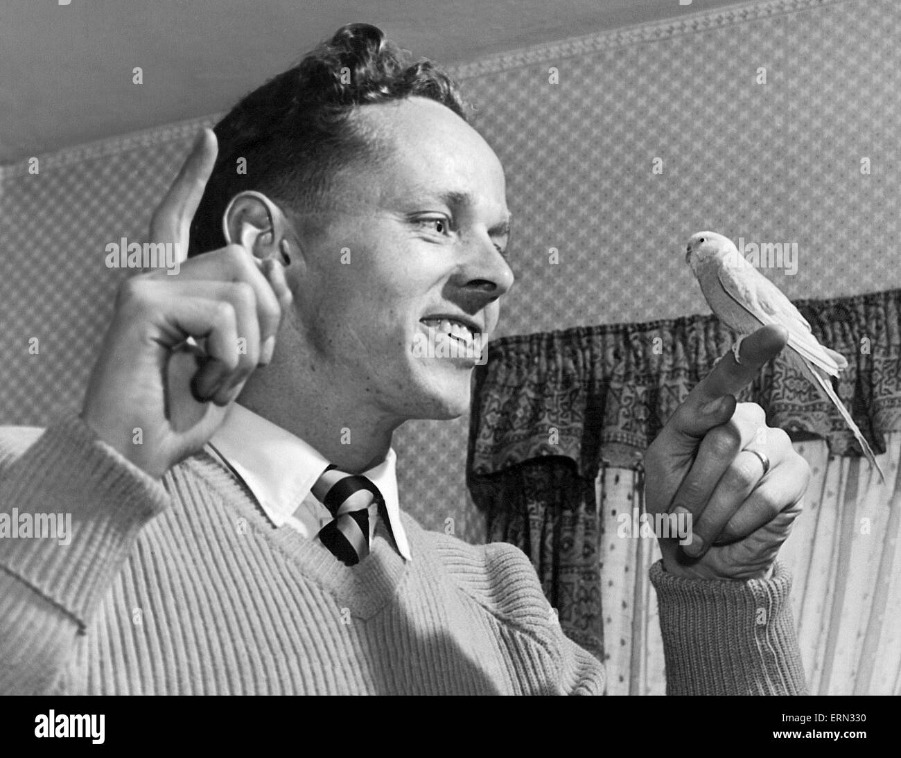 Birmingham City footballer Gordon Astall with a bird on his finger