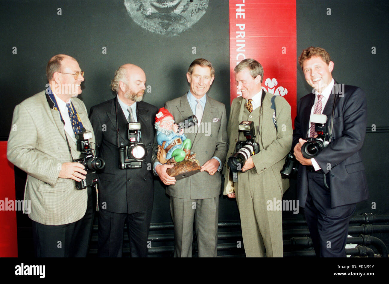 Prince Charles, receives a 50th Birthday gift (his birthday is tomorrow) in the form of a photographer gnome, from Royal Photographers for national titles, The Daily Mirror, The Sun, The Telegraph and The Daily Mail, pictured Friday 13th November 1998. Kent Gavin, Daily Mirror Royal Photographer, pictured 2nd right. Stock Photo