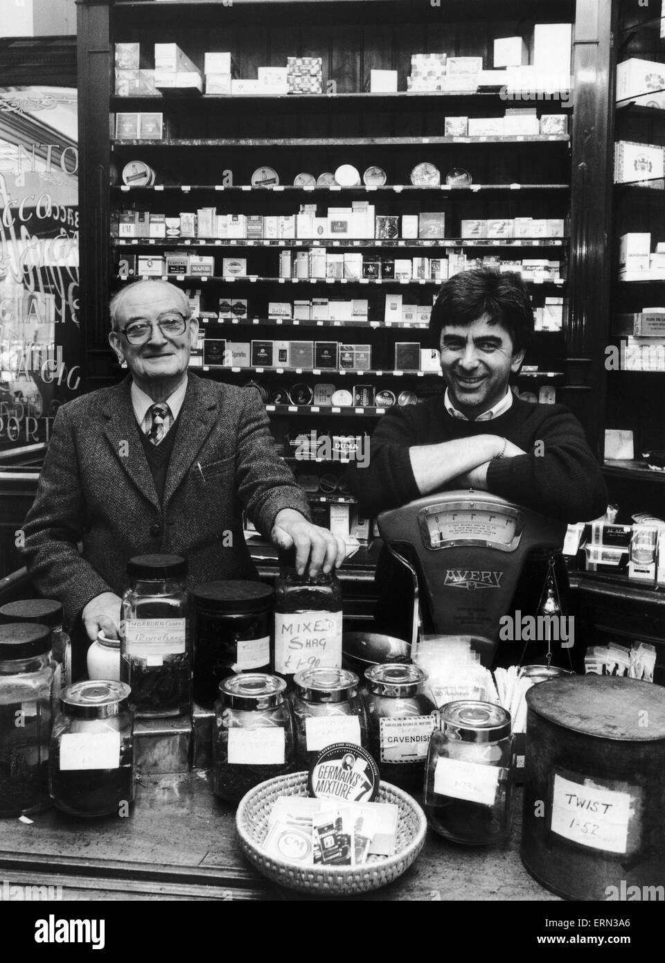 Shop assistant Mr Benjamin Beattie (left) and shop owner Mr Douglas Sparrow seen here behind the counter of F C Benton on the corner of the YMCA building in Peter Street, Manchester 27th September 1987 Stock Photo