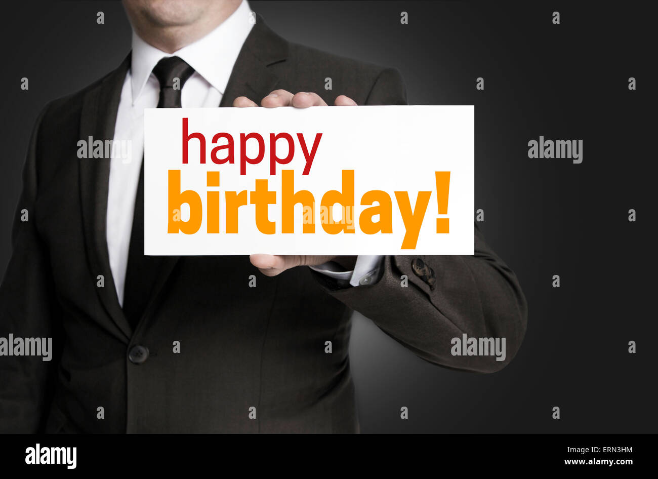 happy birthday sign is held by businessman. Stock Photo