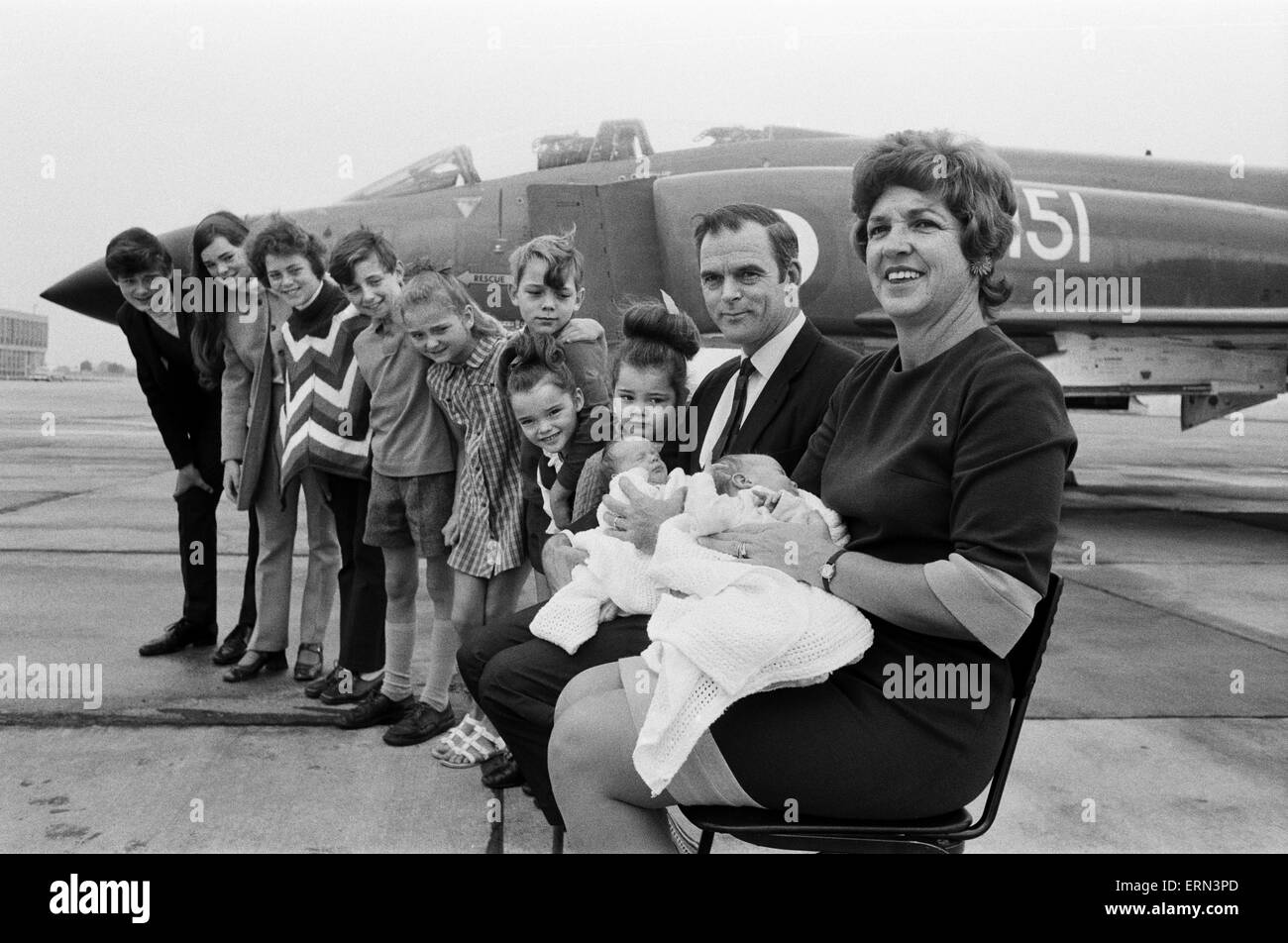 Lieutenant Commander Peter Marshall of HMS Ark Royal and his wife Carolyn, both holding their new born baby twin boys Paul and Mark, pose with their other eight children Kathryn, Ginny, Richard, Melanie, Sally, Carl, Kirstie and Christopher. 24th August 1971. Stock Photo