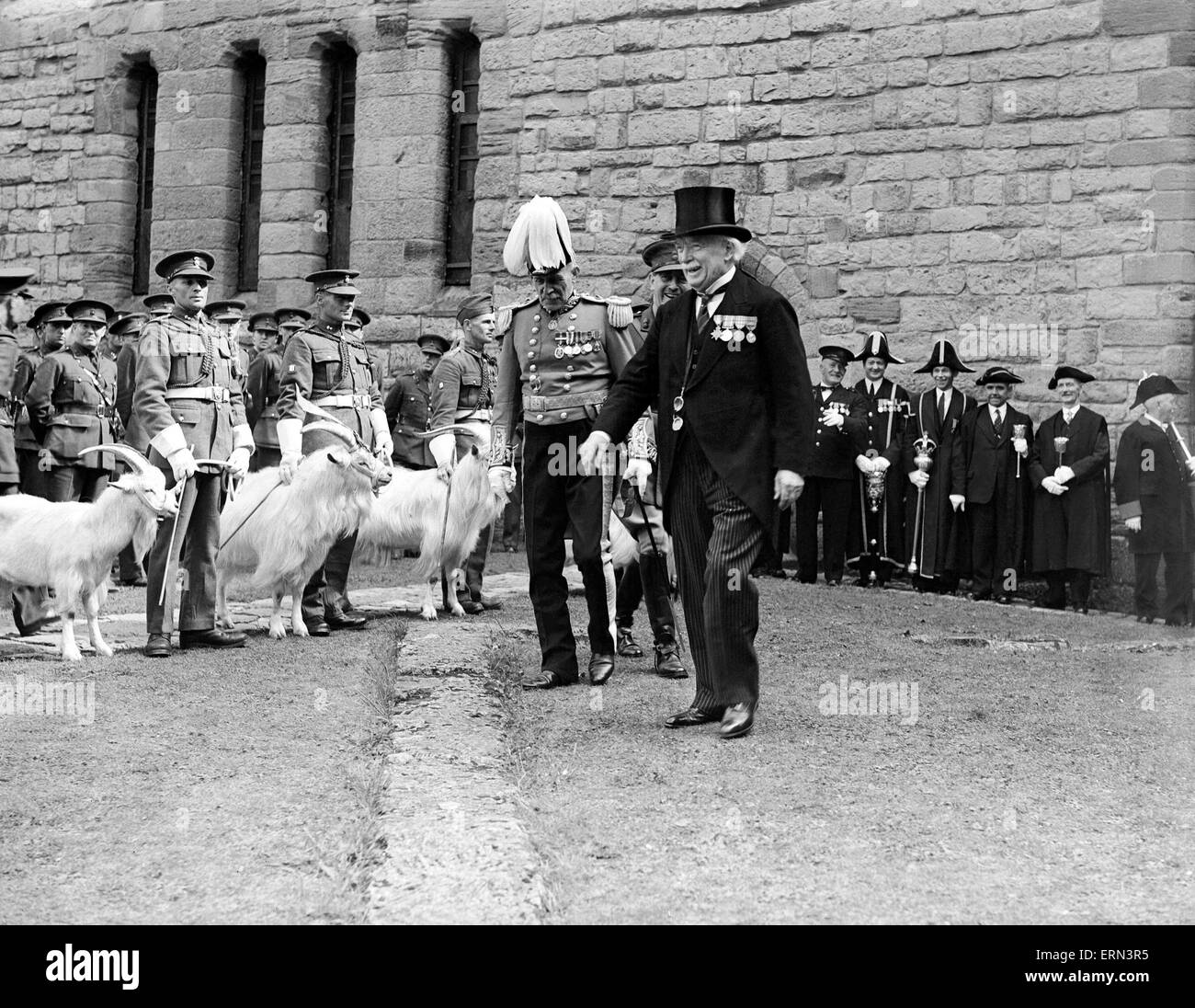 David LLoyd George wearing his decorations, is Constable of Caernarvon Castle and is photographed at the celebration of the Castle of the 250th anniversary of the raising of the Royal Welch Fusiliers. Mr Lloyd seen inspecting a row of goat mascots, 5th August 1939 Stock Photo