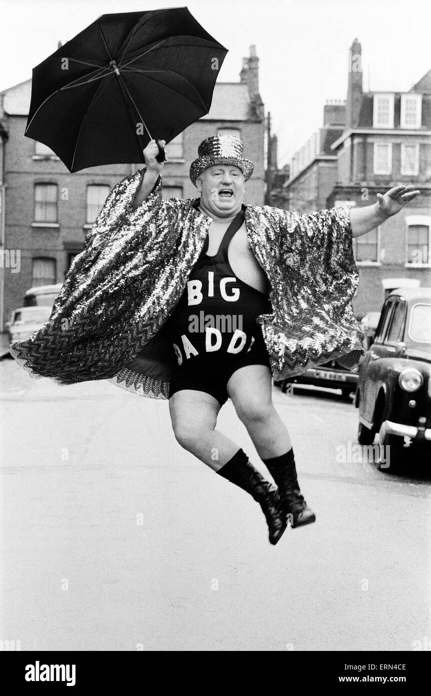 Wrestler Shirley Crabtree alias Big Daddy  jumps in the air with an umbrella and wearing a silver cape as he promotes a new record. March 1980. Stock Photo