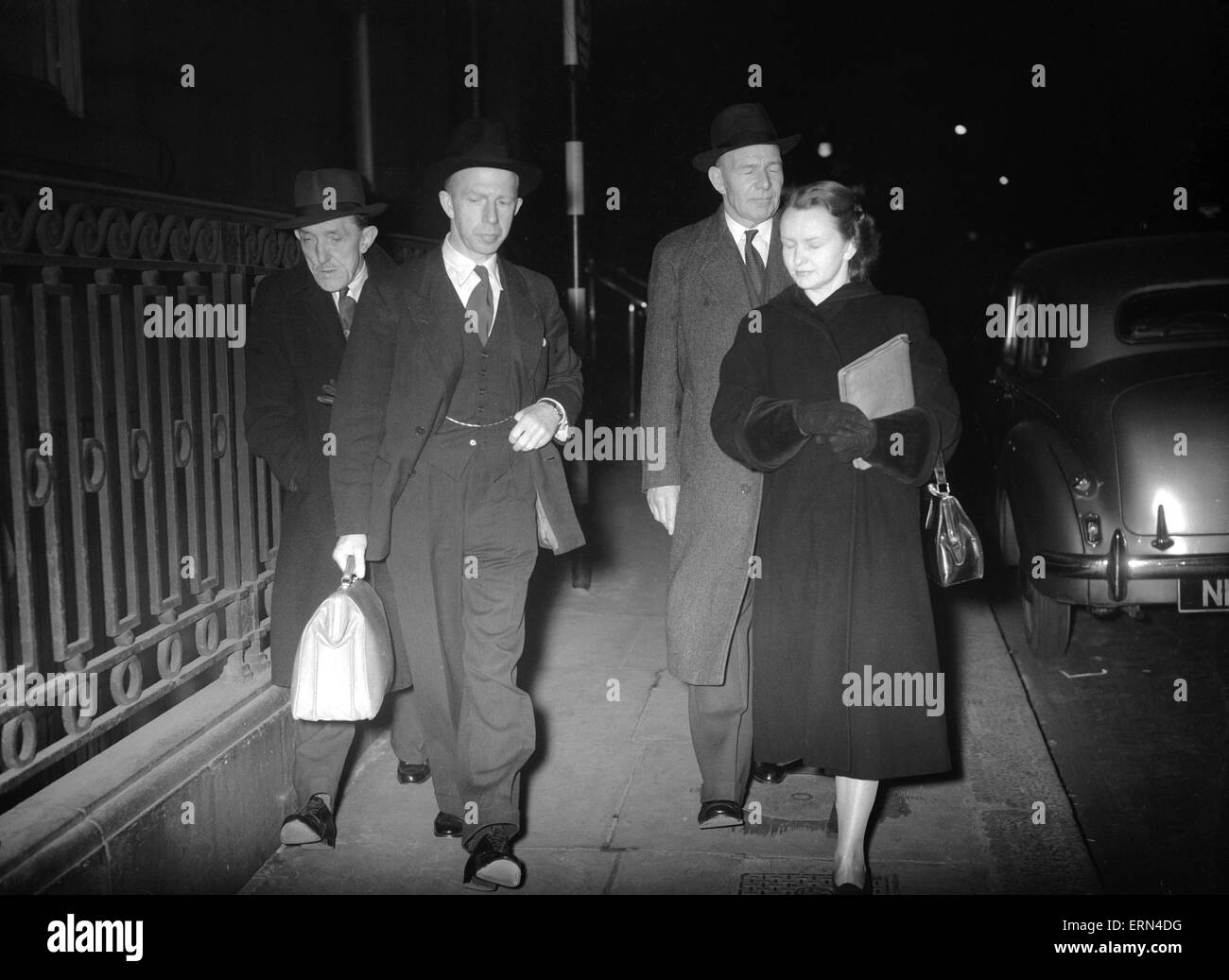 Dr. Keith Simpson (second left) the Home Office pathologist arriving at the Ritz hotel shortly before seven o'clock last night with his secretary Jean Scott Dunn and Detective Superintendent John Burrett (3rd left)  After detectives were called to the exclusive Ritz Hotel  in Piccadilly London after breaking down a door of a bedroom and finding the bodies of a man and a woman. The man was hanging from a wardrobe and the woman lay near him with her throat cut. There were signs of a struggle. It appeared that the man had first attacked the woman and cut her throat with a razor and then hung Stock Photo