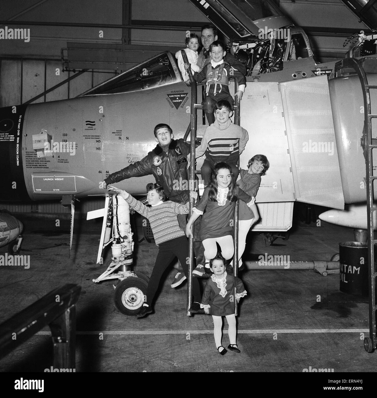 The First Royal Phantom Training Unit will be commissioned at the Royal Training Air Station in Yeovilton, Somerset. Lieutenant Commander Peter Marshall has been chosen to lead the training of the pilots and observers who will fly the fighter version of the aircraft. Here he is pictured with his eight children  at the Air Station. 13th January 1969. Stock Photo