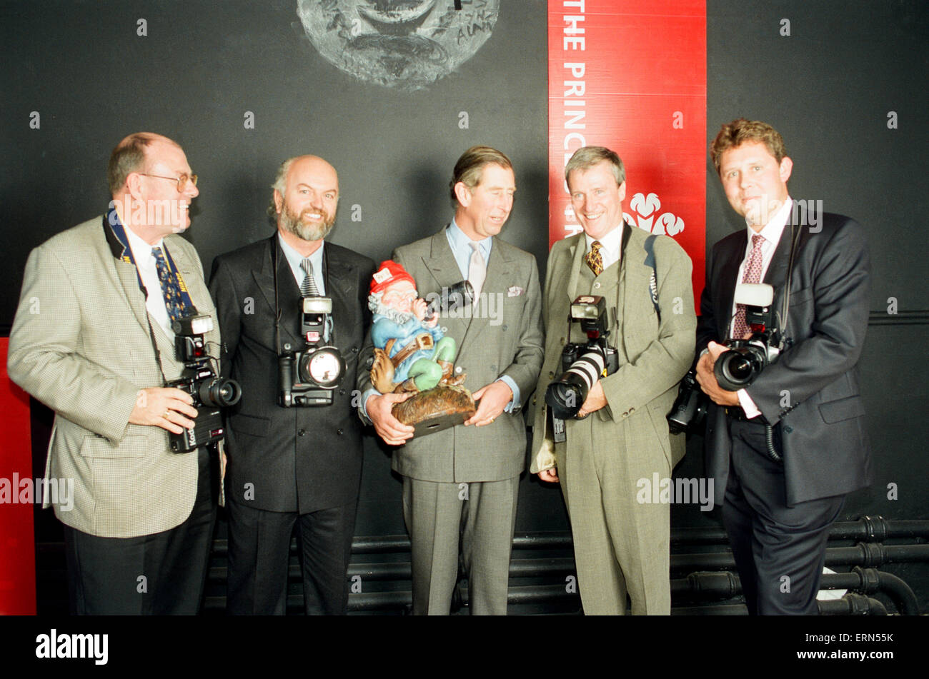 Prince Charles, receives a 50th Birthday gift (his birthday is tomorrow) in the form of a photographer gnome, from Royal Photographers for national titles, The Daily Mirror, The Sun, The Telegraph and The Daily Mail, pictured Friday 13th November 1998. Kent Gavin, Daily Mirror Royal Photographer, pictured 2nd right. Stock Photo