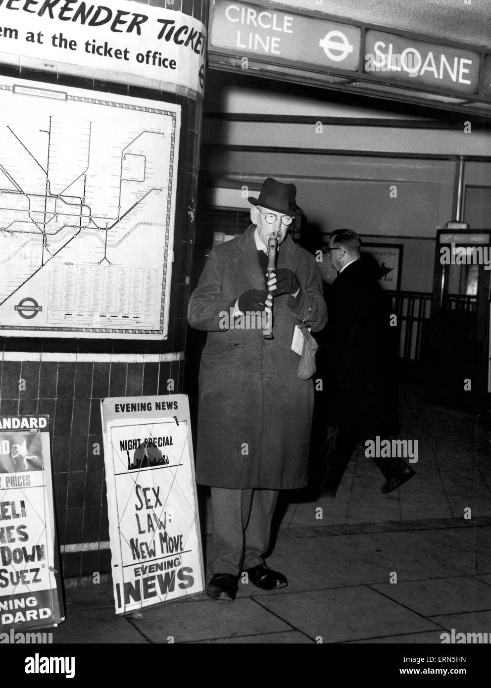 Busker George Russell playing his Recorder outside Sloane Square Tube Station. 4th December 1967. Stock Photo