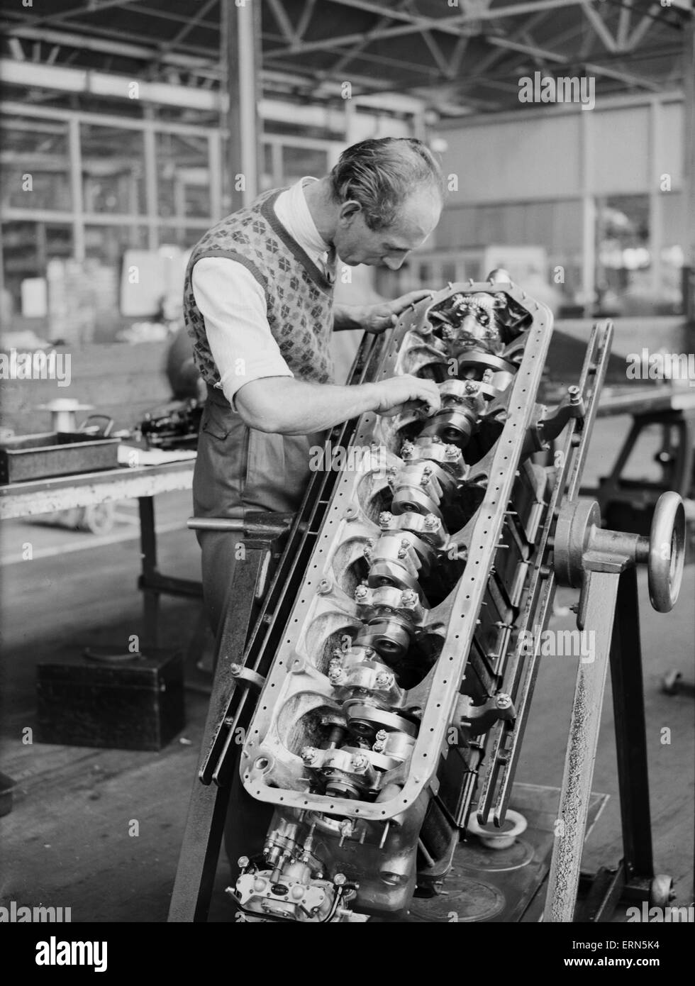 An engineer checks the pistons of the Gipsy Six engine during the construction of the Miles 3 Falcon aircraft at the Philips and Powis factory at Woodley Aerodrome, Reading  2nd April 1934. Stock Photo