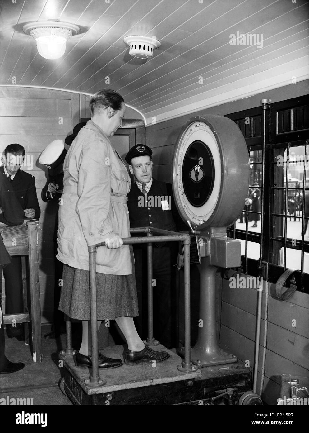 Series of images for Daily Herald Feature flight to Australia. 26th June 1938Series of images for Daily Herald Feature flight to Australia. 26th June 1938 Passengers bound for Australia are weighed at Paddington Station prior to their departure to Southampton, so Imperial Airways staff know how much cargo and mail can be loaded  aboard the flight for Brisbane Stock Photo