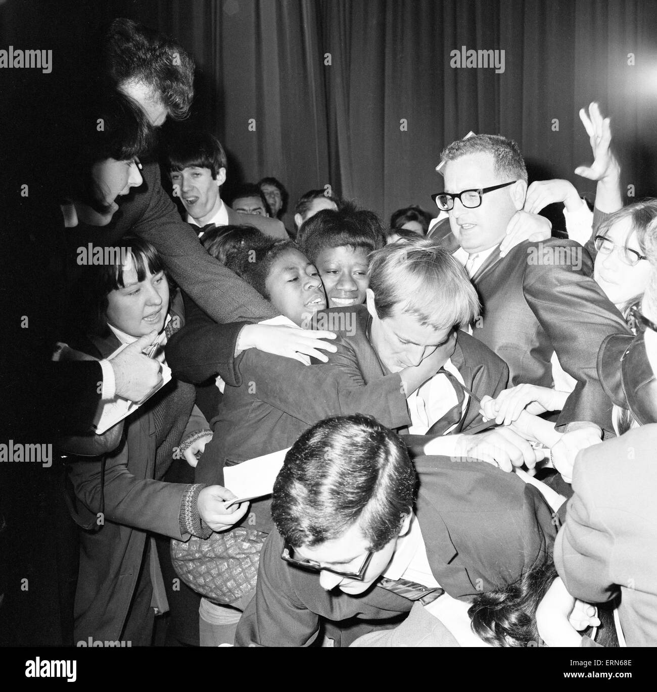 David McCallum, actor who plays the role of secret agent Illya Kuryakin in NBC show The Man from U.N.C.L.E., mobbed by screaming teenagers while attending news press conference at the Empire Cinema, Leicester Square, London, 17th March 1966. UK Promotion Stock Photo