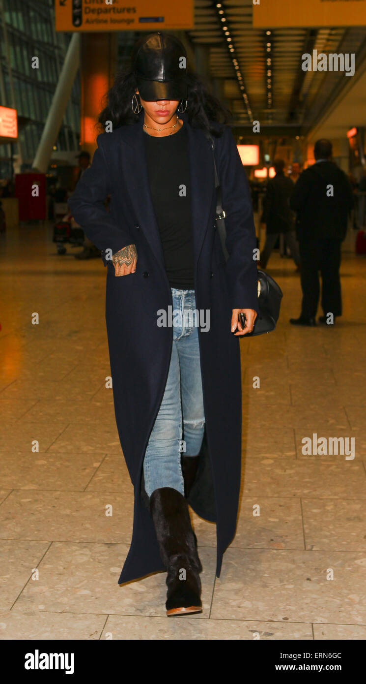 Rihanna arrives at London Heathrow wearing a full length winter coat and  fur boots Featuring: Rihanna Where: London, United Kingdom When: 01 Dec  2014 Credit: WENN.com Stock Photo - Alamy