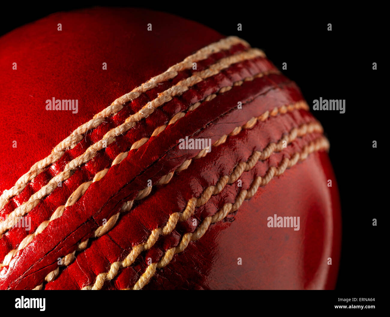 Red Leather Cricket Ball on black Stock Photo
